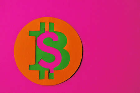 Bitcoin is connected to the dollar on a pink background with a copy space. Conceptual collage about cryptocurrency in the power of minimalismの写真素材