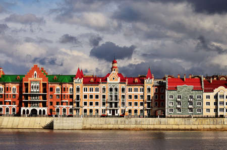 A panorama of the building on the embankment of Bruges under gloomy clouds. Russia Yoshkar Ola 01.05.2021のeditorial素材