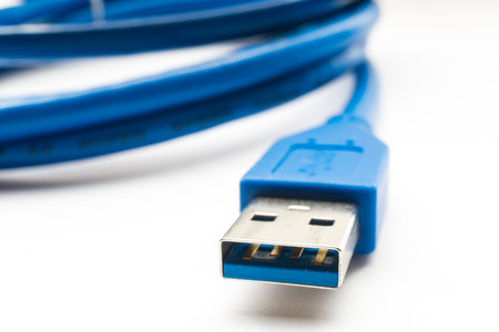 Blue usb connector close up on white background. Macro shot, selective focus
