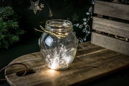 Sparkler in glas jar on dark wooden background. New year, christmas conceptの写真素材