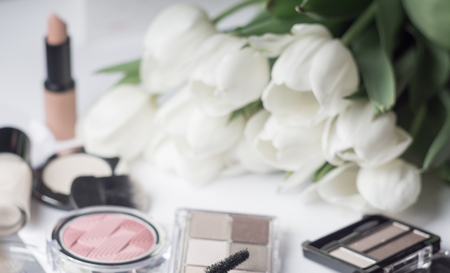 Abstract blurred background, cosmetics set and tulips flowers on white. Macro shot, Shallow depth of field, defocusedの写真素材