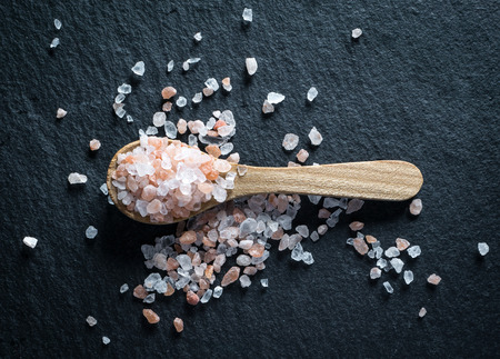 Wooden spoon with pink himalayan saltの写真素材
