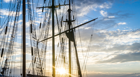 Mast and rope sailboat vessel on sky sunset background. Sailing conceptの写真素材