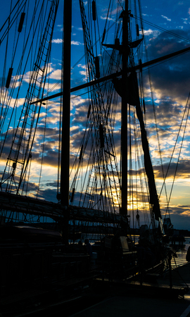Mast and rope sailboat vessel on sky sunset background. Sailing conceptの写真素材