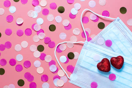 card for valentine's day. on a pink background medical masks and two red hearts. funny...