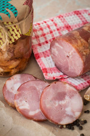 homemade village ham and canned meat. pork, red meat. garlic and allspice. decorated in craft paper,...