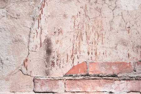 old brick wall. cracked concrete. pink, brown texture backgroundの写真素材