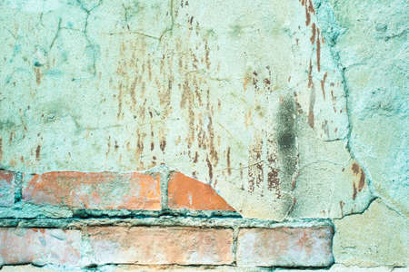 old brick wall. cracked concrete. turquoise, blue, brown texture. vintage background