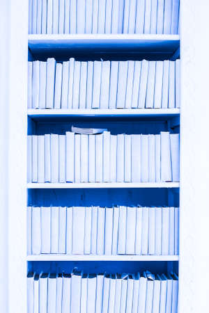 wardrobe with blue books. decor element. texture, background. wall. literature, library.の写真素材