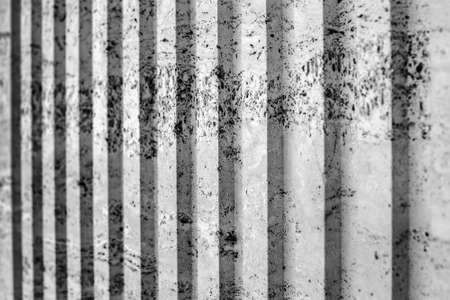 black and White vertical stripe plastered wall. old background with cracks and scuffs