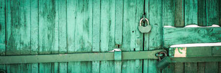 banner. rusty lock on a texture of old, wooden, Green tide, celadon door. the passage is closed....
