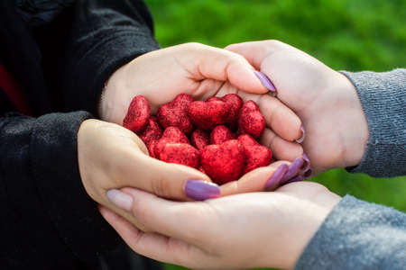 female hands give a shiny hearts. mothers Day. Mom and daughter. Concept of the care, love, Christmas, Valentine's Day.の写真素材