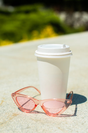 paper, plastic coffee cup. blurred background, sunny day. space for text, space for copy. summerの写真素材