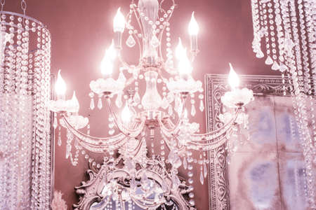 Crystal chandelier close-up. pink light. Selective focus.の写真素材