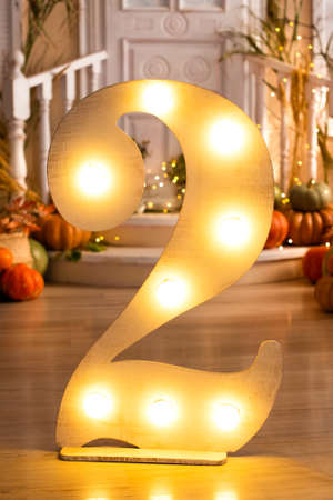 decorations for the second birthday. party of two years. number 2, lamps and pumpkins near the porch
