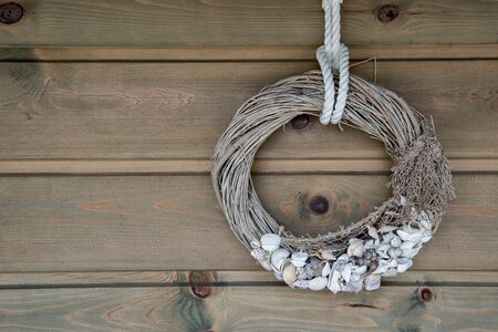 Wooden wall decoration with Sea thematic frame, decorated with seashells. Marine themes in hand work for interior decoration.の写真素材