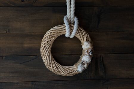 Dark brown Wooden wall decoration with Sea thematic frame, decorated with seashells.の写真素材