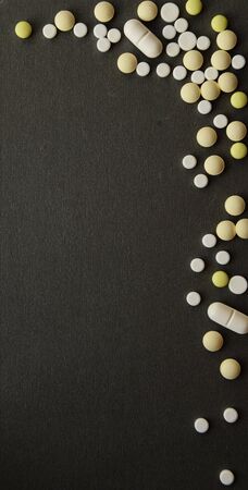 Pharmacology assorted medicine pills, tablets and capsules. Different colors white yellow tablet on...