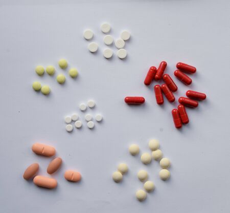 Pharmacology assorted medicine pills, tablets and capsules. Different colors tablet on white...
