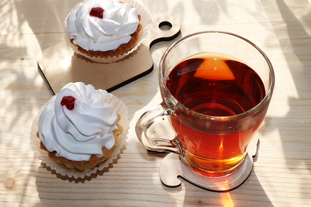 A cup of tea and cakes on a sunny table, diet food and a healthy lifestyle in the village, a beautiful morning in the village, a delicious dessert.の写真素材