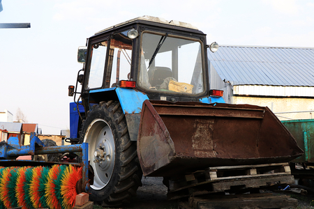 Russia, Leningrad region, April 26, 2019, Russian village. Russian village in spring and a tractor that prepares for tillage,harsh realityのeditorial素材