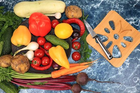Vegetables summer on a dark background, top view, copy space. Pepper, dill, tomato, onion, beet, cucumber, zucchini, salad ingredients, healthy eating and diet concept.の写真素材