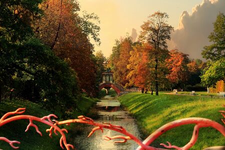Russia, St. Petersburg, September 22, 2018, Alexander Park. Pictured is an autumn pond with bright autumn leaves and a Chinese bridge in dense fog. The beauty of the October forestのeditorial素材