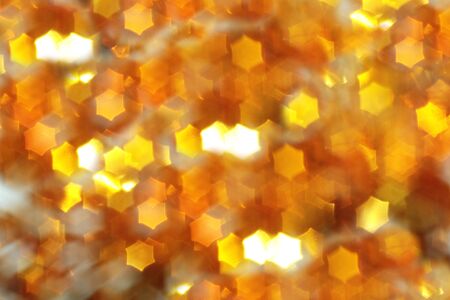 Christmas background and new year concept, abstract defocused light background with bokeh and blur, yellow. Winter banner for your text, background image or layer for overlay in the photo editor, out of focusの写真素材