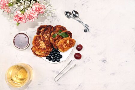 Pancakes with berries, blueberries and grapes, on a sunny sunny background. The concept of healthy...
