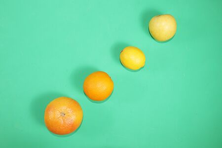 Summer banner, citrus fruits, grapefruit, orange, lemon on a bright green background, minimal concept of relaxation and detox, diet and weight loss. Place for text,の写真素材