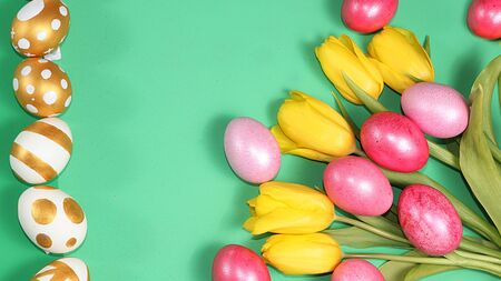 Decorated golden and blue Easter eggs on a trendy green background. Minimal holiday concept. Happy Easter background, place for text, postcard, bannerの写真素材
