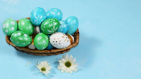 Decorated golden eggs on a trendy blue background. Minimal holiday concept. Happy Easter background,...