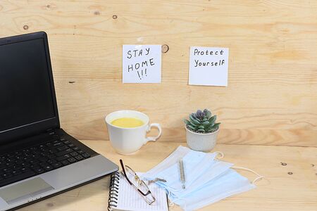 Home office, Hand sanitizers, medical masks, computer. Protection against coronavirus Covid 19, the concept of stay home, Hygiene, protection against epidemics, colds,の写真素材