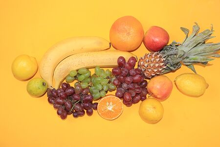 Fruits on a yellow background. The concept of healthy and natural foods to enhance immunity, a...