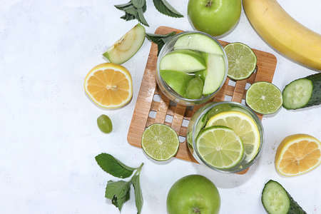 Vegetables, fruits, juice and smoothies on a light background flat lay. The concept of healthy and natural food for weight loss, lifestyle, detox diet, the purpose of which is to eliminate carbohydrates and cleanse the body, a place for textの写真素材