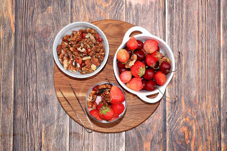 Healthy breakfast, food for children, strawberry yogurt, smoothies and granola, strawberries on a wooden table. The concept of healthy and natural food. selective focusの写真素材
