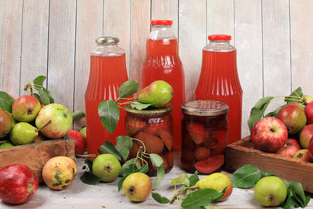 Apple and pear cider, juice, fruit drink and ingredients on a sunny table, home canning. The concept...