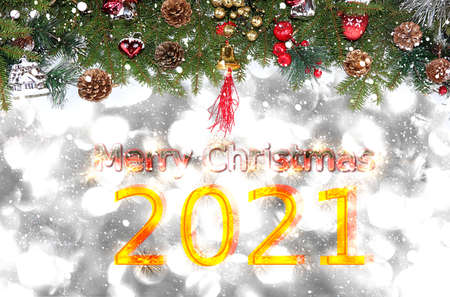Happy new year 2021 background with bokeh lights, branches with balls and ribbons in snow flakes....