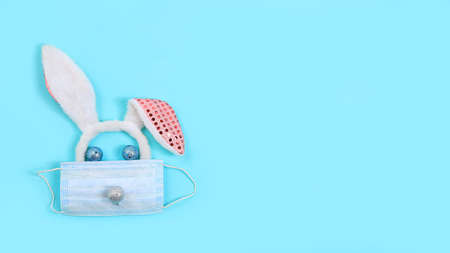 Christmas composition with decorations and medical mask, greeting card, minimal holiday concept, modern new year background, banner for the screen, space for text,の写真素材