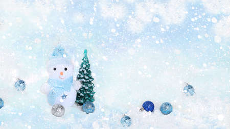 New year background and new year concept, beautiful holiday decorations and snowman on light defocused snow background, postcard, winter banner,の写真素材