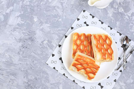 Pies with cottage cheese on a light table with honey and milk, Cheesecakes with wicker dough. Modern...