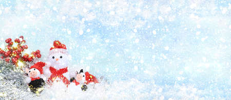 New year background and new year concept, beautiful holiday decorations and snowman on light defocused snow background, postcard,の写真素材