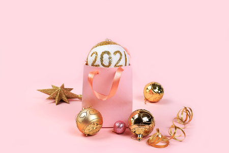 Christmas composition with decorations, gift bag and toys, postcard, minimal holiday shopping...