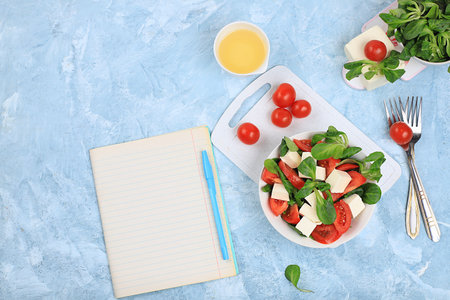 Caprese with mozzarella cheese, cherry tomatoes and fresh arugula, Useful natural breakfast with lemon, detox diet.Traditional Italian food ,, cholesterol-free and GMO-free, selective focus, place for text,の写真素材