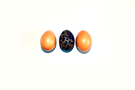 Decorated golden Easter eggs on a light background. Holiday minimal concept, postcard, Happy Easter...