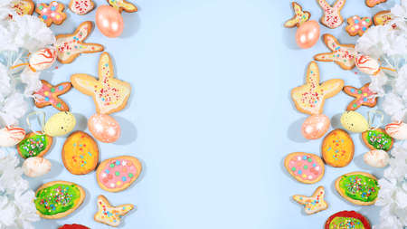 Happy Easter concept, spring card, composition with flowers, cookies and eggs on a gentle background. Holiday minimal concept, home baking ideas, place for text, banner for screen, selective focusの写真素材