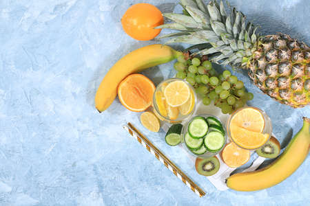 Detox diet and weight loss concept. Fruit drink and ingredients, summer tropical fruits and...
