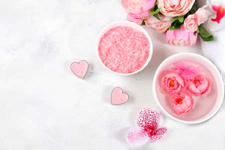 Spa and wellness composition with aromatic rose water, salt, roses and sakura, towels, aromatherapy and skin care, lifestyle concept, invitation and advertising card,の写真素材
