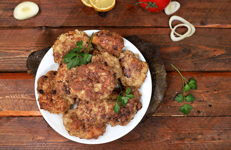 Homemade cutlets with onions, tomatoes and garlic, spicy herbs