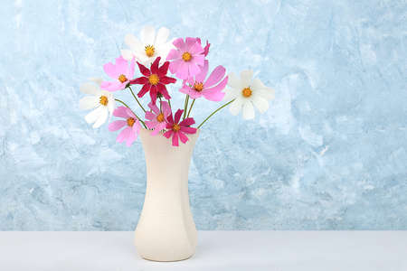 Daisy flowers in a vase, Abstract floral arrangement, spring or autumn background with place for...